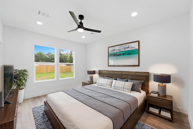 821 Empire St, El Campo, TX 77437 - bedroom with light wood-type flooring, baseboards, a ceiling fan, and recessed lighting