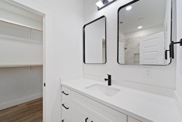 821 Empire St, El Campo, TX 77437 - full bath featuring vanity, wood finished floors, a spacious closet, recessed lighting, and a shower
