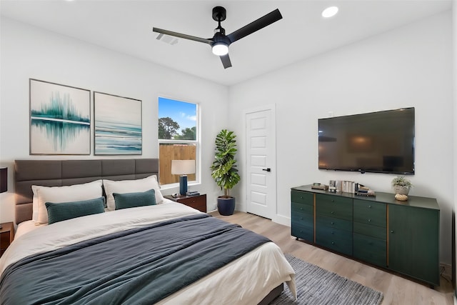 821 Empire St, El Campo, TX 77437 - bedroom featuring light wood-style flooring, ceiling fan, and recessed lighting
