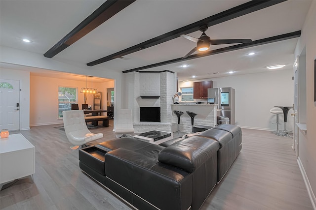 12602 Westleigh Dr, Houston, TX 77077 - living room featuring beam ceiling, baseboards, light wood-style flooring, a chandelier, and ceiling fan