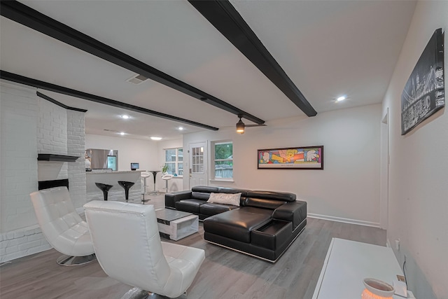 12602 Westleigh Dr, Houston, TX 77077 - living area featuring beam ceiling, wood finished floors, baseboards, a brick fireplace, and recessed lighting