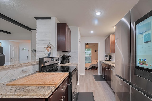 12602 Westleigh Dr, Houston, TX 77077 - kitchen featuring stainless steel appliances, light wood finished floors, backsplash, dark brown cabinets, and recessed lighting