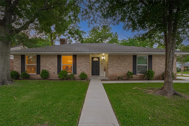 12602 Westleigh Dr, Houston, TX 77077 - ranch-style house with a front yard, brick siding, a chimney, and a shingled roof