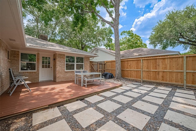 12602 Westleigh Dr, Houston, TX 77077 - fenced backyard with a wooden deck, outdoor dining space, and a patio area