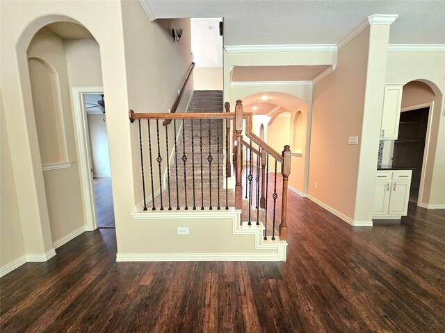 23122 Biddle Dr, Porter, TX 77365 - stairs featuring wood finished floors, ornamental molding, baseboards, and arched walkways