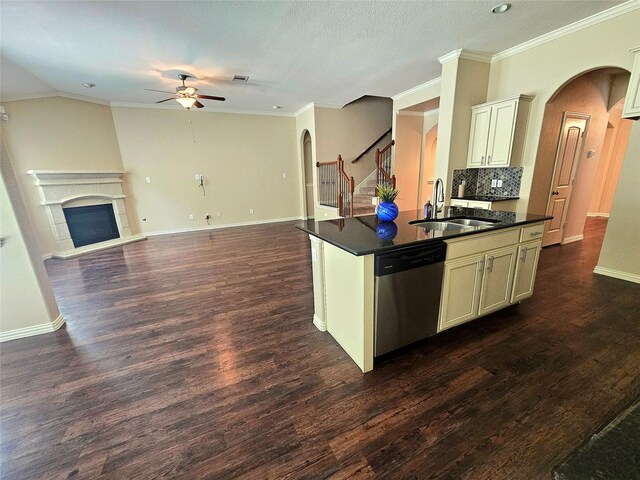 23122 Biddle Dr, Porter, TX 77365 - kitchen with stainless steel dishwasher, a sink, a ceiling fan, dark countertops, and arched walkways