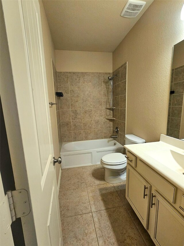 23122 Biddle Dr, Porter, TX 77365 - bathroom with toilet, vanity, shower / washtub combination, a textured wall, and tile patterned flooring