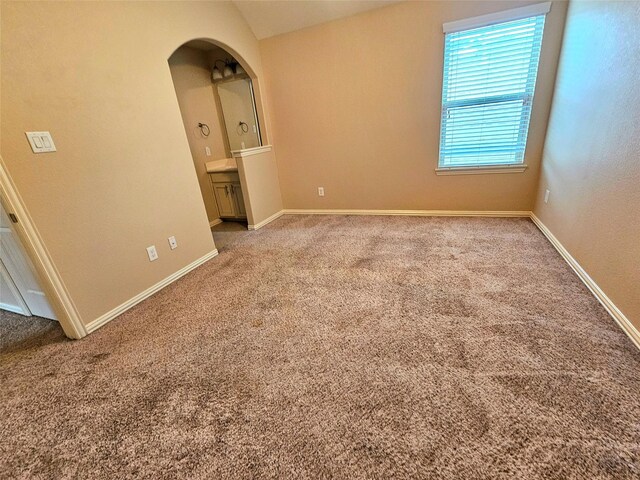 23122 Biddle Dr, Porter, TX 77365 - unfurnished room with carpet floors, arched walkways, and baseboards
