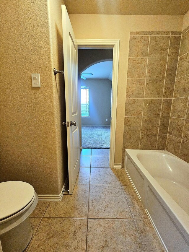 23122 Biddle Dr, Porter, TX 77365 - bathroom with toilet, a textured wall, tile patterned floors, and baseboards