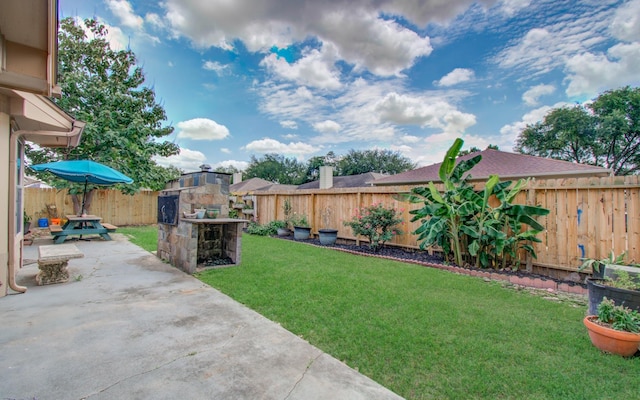 3359 Tenaha Dr, Houston, TX 77014 - view of yard with an outdoor stone fireplace and a patio area