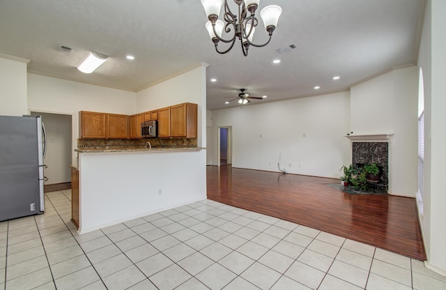 3359 Tenaha Dr, Houston, TX 77014 - kitchen featuring stainless steel appliances, open floor plan, light tile patterned flooring, crown molding, and a ceiling fan