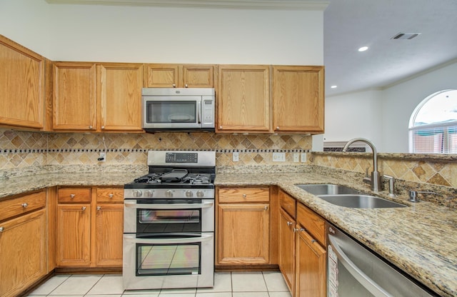 3359 Tenaha Dr, Houston, TX 77014 - kitchen featuring appliances with stainless steel finishes, a sink, crown molding, tasteful backsplash, and light tile patterned flooring