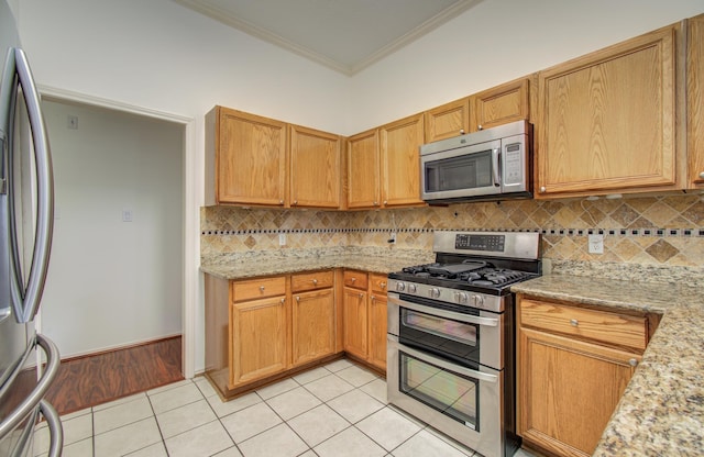 3359 Tenaha Dr, Houston, TX 77014 - kitchen with stainless steel appliances, crown molding, light tile patterned flooring, decorative backsplash, and light stone countertops