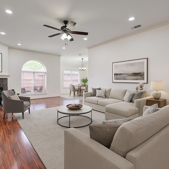 3359 Tenaha Dr, Houston, TX 77014 - living room with recessed lighting, wood finished floors, a ceiling fan, crown molding, and a chandelier