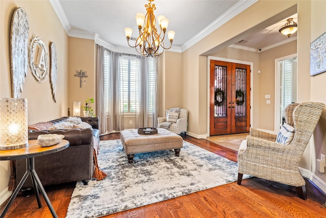 2509 Creektrail Ln, Richmond, TX 77406 - living area featuring wood finished floors, a chandelier, ornamental molding, and baseboards