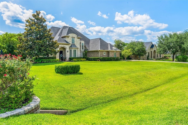 2509 Creektrail Ln, Richmond, TX 77406 - view of front of home with stone siding and a front yard