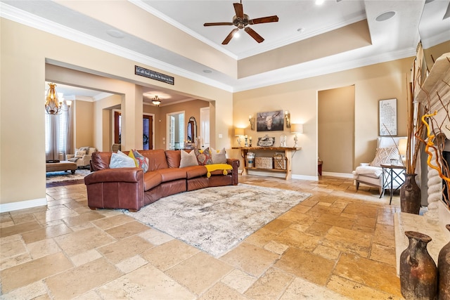 2509 Creektrail Ln, Richmond, TX 77406 - living room with stone tile flooring, crown molding, ceiling fan, baseboards, and a tray ceiling