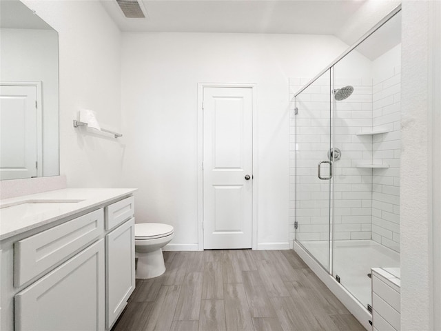 5667 Foggy Vine Ct, Fulshear, TX 77441 - bathroom featuring vanity, a stall shower, wood finished floors, toilet, and baseboards