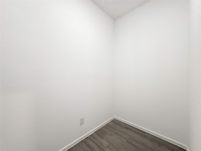 5667 Foggy Vine Ct, Fulshear, TX 77441 - unfurnished room with dark wood-type flooring, baseboards, and lofted ceiling