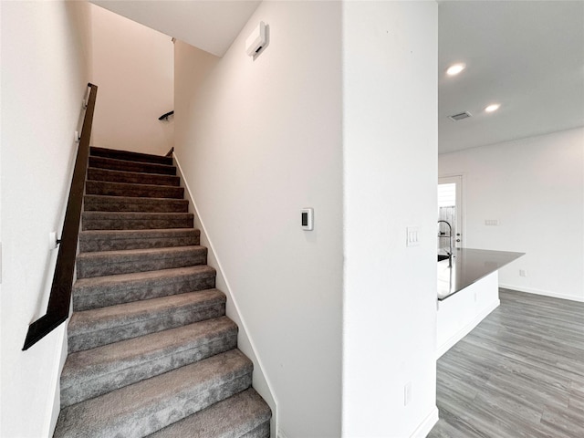 5667 Foggy Vine Ct, Fulshear, TX 77441 - staircase with recessed lighting, wood finished floors, and baseboards