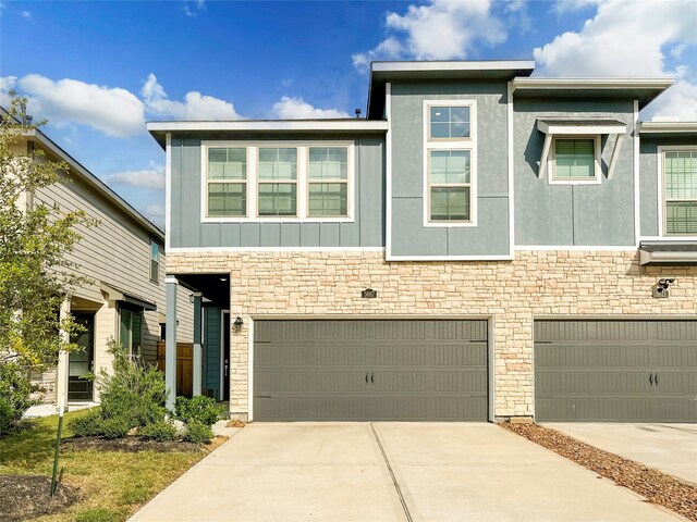 5667 Foggy Vine Ct, Fulshear, TX 77441 - view of front facade featuring a garage, stone siding, and driveway