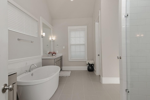 2205 Salt Grass Trl, Conroe, TX 77384 - full bath featuring vanity, a freestanding tub, tile patterned floors, and vaulted ceiling