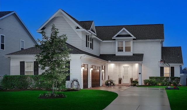 2205 Salt Grass Trl, Conroe, TX 77384 - view of front of house with a garage, roof with shingles, a front lawn, and driveway