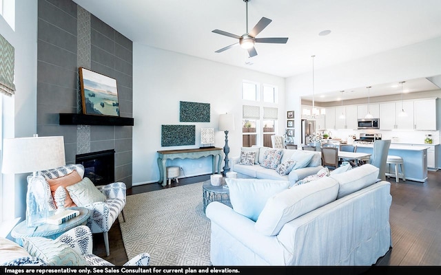 12130 Wooden Mill Ln, Santa Fe, TX 77510 - living area with dark wood-type flooring, ceiling fan, and a tile fireplace