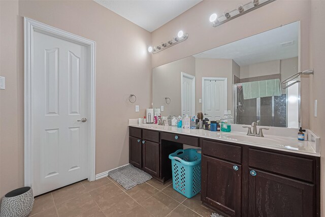 24623 Forest Hiker Ct, Katy, TX 77493 - full bathroom with double vanity, a stall shower, tile patterned flooring, and baseboards
