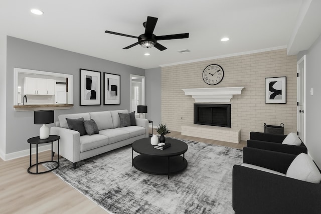 1509 Chestnut Ln, Richmond, TX 77469 - living room with light wood finished floors, a ceiling fan, brick wall, a brick fireplace, and recessed lighting