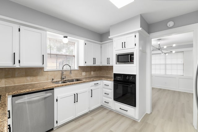 1509 Chestnut Ln, Richmond, TX 77469 - kitchen featuring appliances with stainless steel finishes, light wood-style flooring, and white cabinets