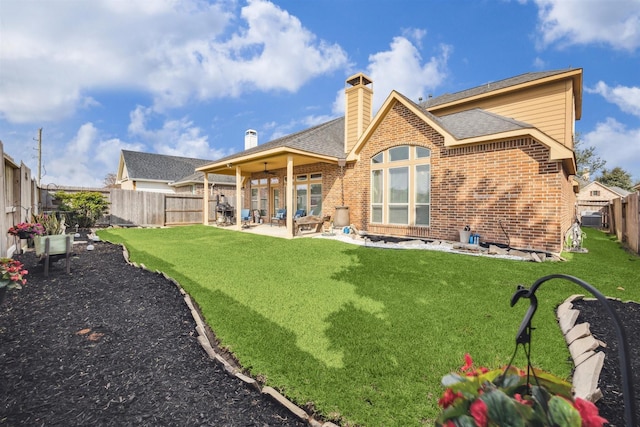 28915 Davenport Dr, Katy, TX 77494 - rear view of house with brick siding, a patio area, a chimney, and a shingled roof