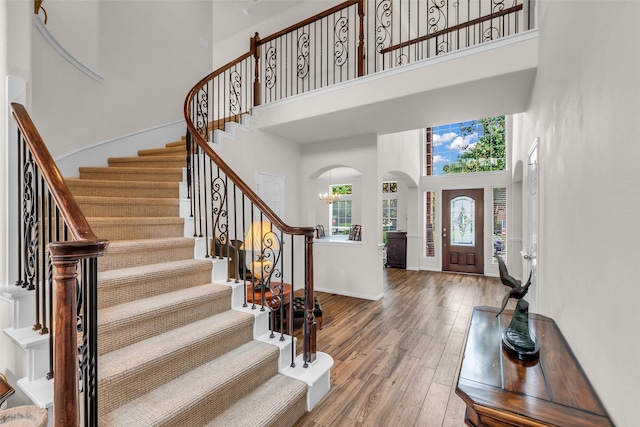 6406 Pine Reserve Dr, Spring, TX 77389 - entryway featuring a high ceiling, arched walkways, wood finished floors, and stairs