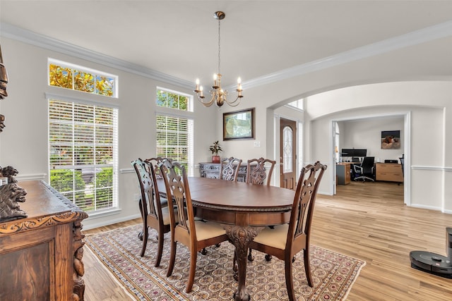 6406 Pine Reserve Dr, Spring, TX 77389 - dining space with arched walkways, crown molding, a chandelier, light wood-style floors, and a desk