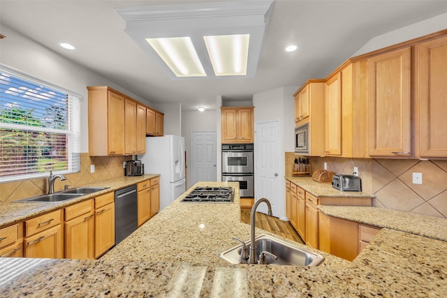 6406 Pine Reserve Dr, Spring, TX 77389 - kitchen with stainless steel appliances, backsplash, light stone counters, recessed lighting, and light brown cabinets
