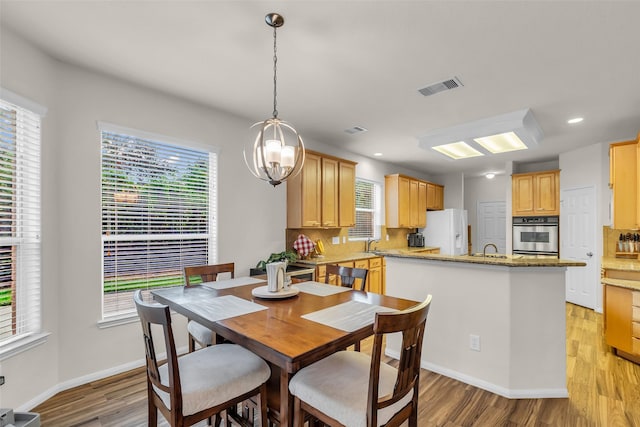 6406 Pine Reserve Dr, Spring, TX 77389 - dining space featuring light wood-style flooring, a chandelier, and recessed lighting