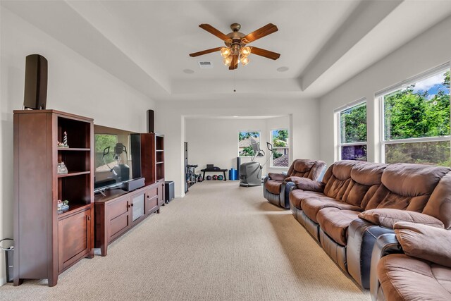6406 Pine Reserve Dr, Spring, TX 77389 - living room with a raised ceiling, light carpet, and a ceiling fan