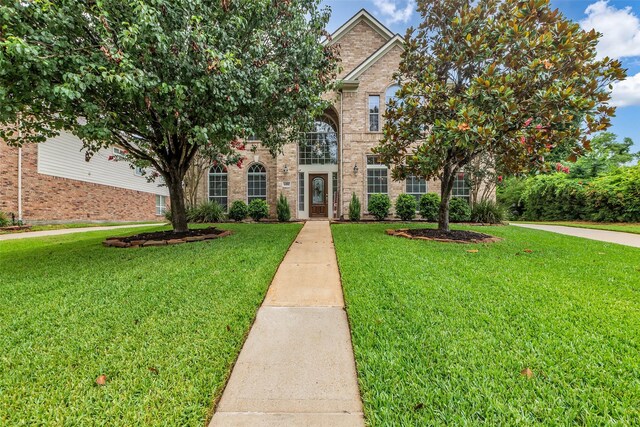 6406 Pine Reserve Dr, Spring, TX 77389 - view of front facade featuring a front yard and brick siding