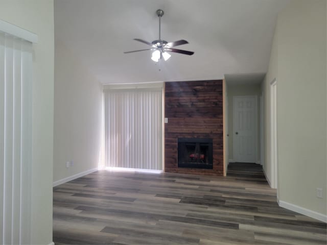 11544 Springshire Dr, Houston, TX 77066 - unfurnished living room featuring a ceiling fan, wood finished floors, baseboards, vaulted ceiling, and a fireplace