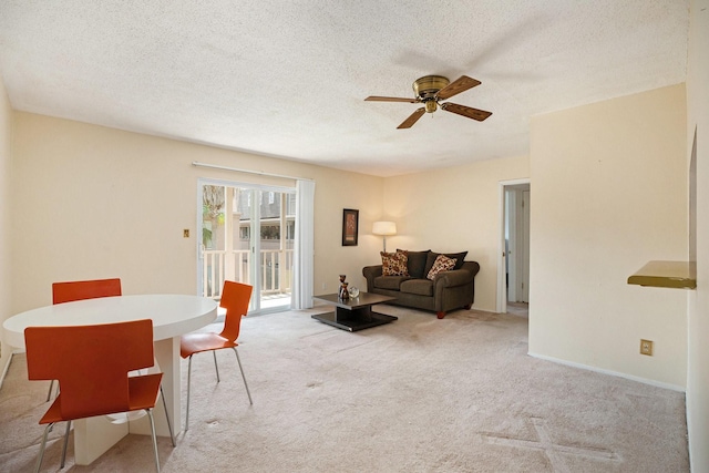 215 Postoffice St Unit 508, Galveston, TX 77550 - living room with ceiling fan, carpet flooring, and a textured ceiling