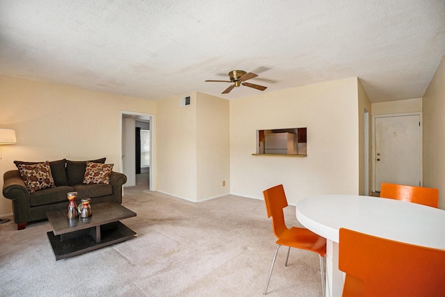 215 Postoffice St Unit 508, Galveston, TX 77550 - carpeted living room featuring a ceiling fan, a textured ceiling, and baseboards