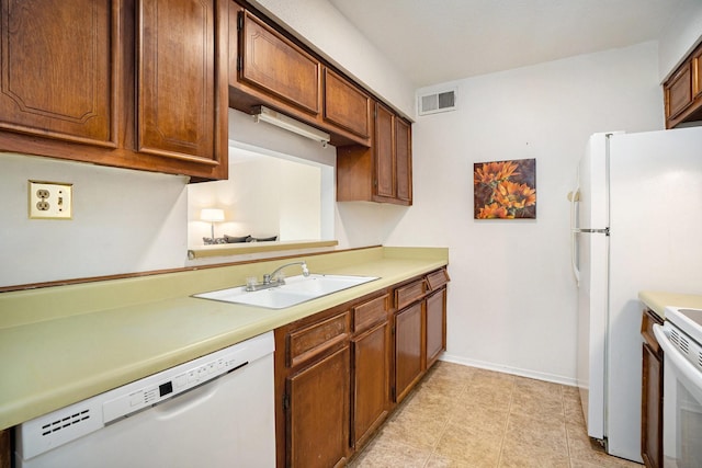 215 Postoffice St Unit 508, Galveston, TX 77550 - kitchen featuring white appliances, a sink, light countertops, and baseboards