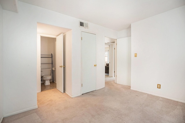 215 Postoffice St Unit 508, Galveston, TX 77550 - unfurnished bedroom with light colored carpet, baseboards, and ensuite bathroom