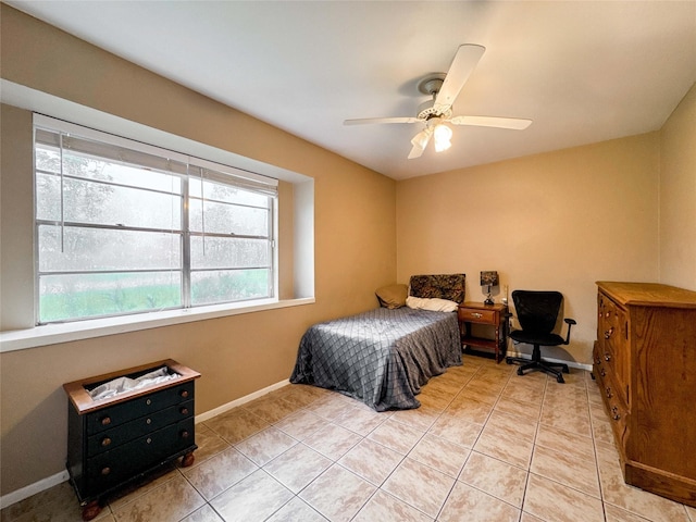 720 E Murray St, Angleton, TX 77515 - bedroom featuring multiple windows, light tile patterned floors, baseboards, and ceiling fan