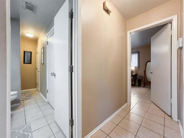 720 E Murray St, Angleton, TX 77515 - hallway featuring light tile patterned floors and baseboards