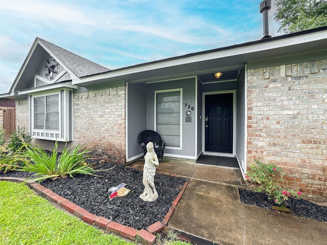 720 E Murray St, Angleton, TX 77515 - property entrance with brick siding and a shingled roof