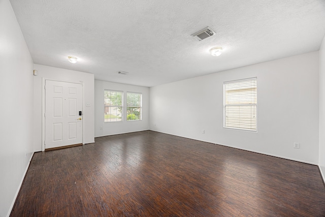 19130 Yaupon Ranch Dr, Cypress, TX 77433 - empty room featuring dark wood-type flooring and a textured ceiling