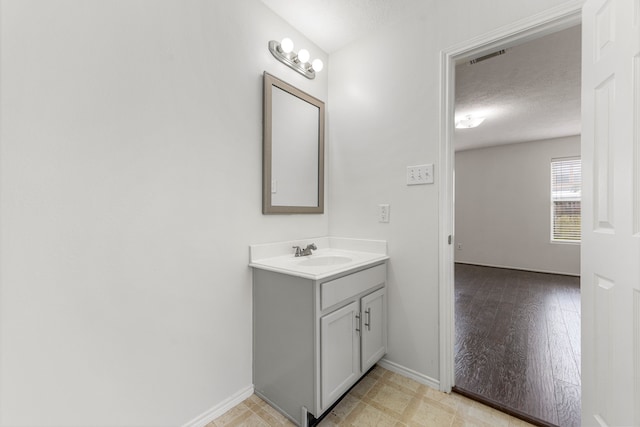 19130 Yaupon Ranch Dr, Cypress, TX 77433 - bathroom featuring vanity, a textured ceiling, and baseboards