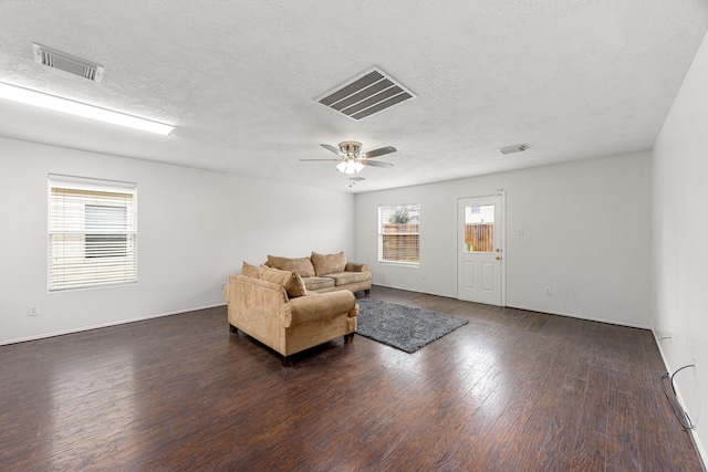 19130 Yaupon Ranch Dr, Cypress, TX 77433 - living area with dark wood-style flooring, a ceiling fan, a textured ceiling, and baseboards