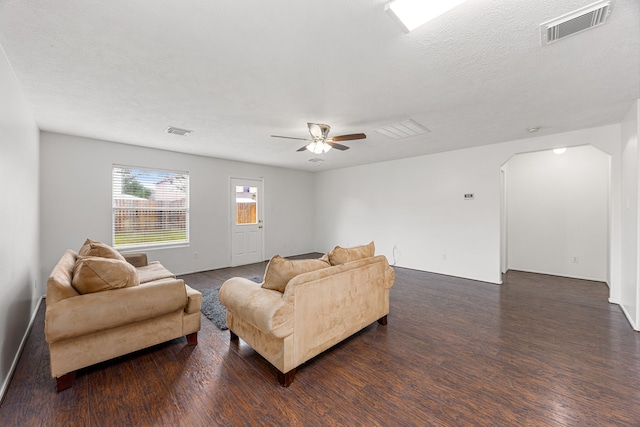 19130 Yaupon Ranch Dr, Cypress, TX 77433 - living room featuring wood finished floors, arched walkways, a ceiling fan, and baseboards